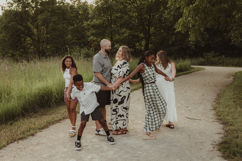 Family laughing together during a candid outdoor photography session on the trails at Cuba Marsh Forest Preserve in Deer Park, Illinois.
