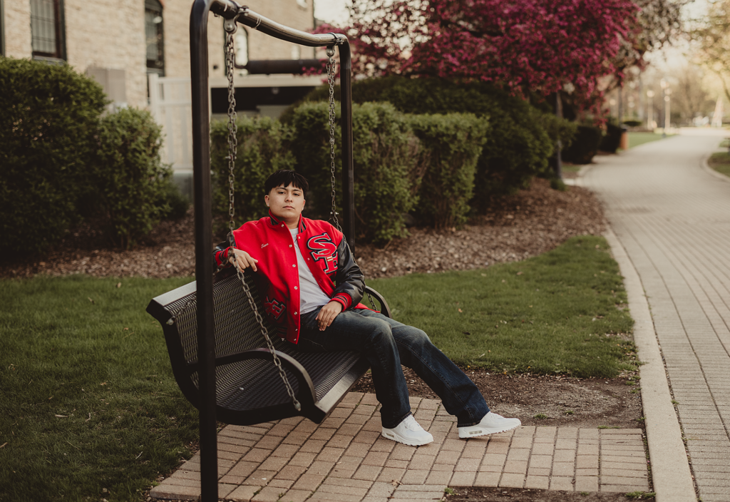 South Elgin High School senior sitting on a swing bench during a Downtown Batavia senior session