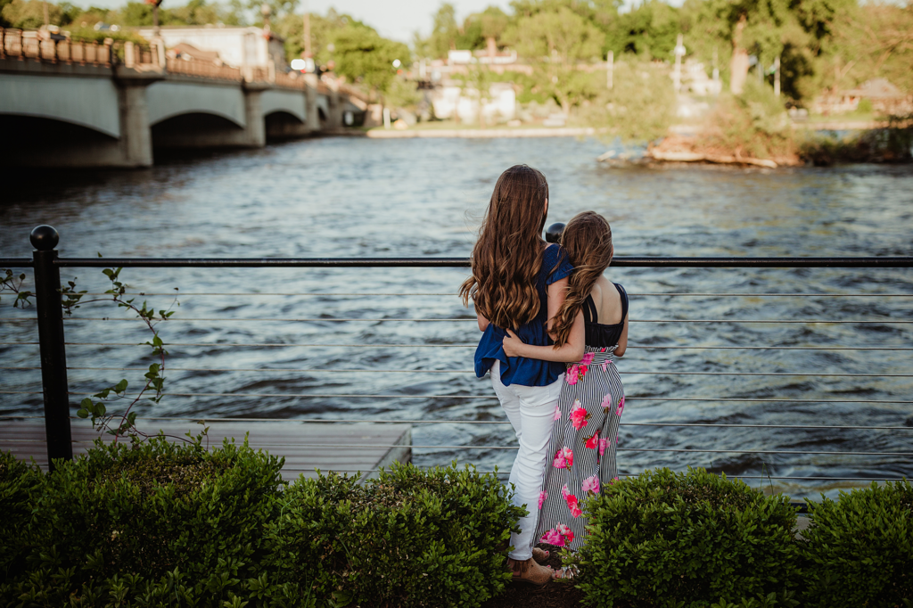 Two sisters standing together overlooking the Fox River behind the Herrington Inn & Spa in Geneva, Illinois.