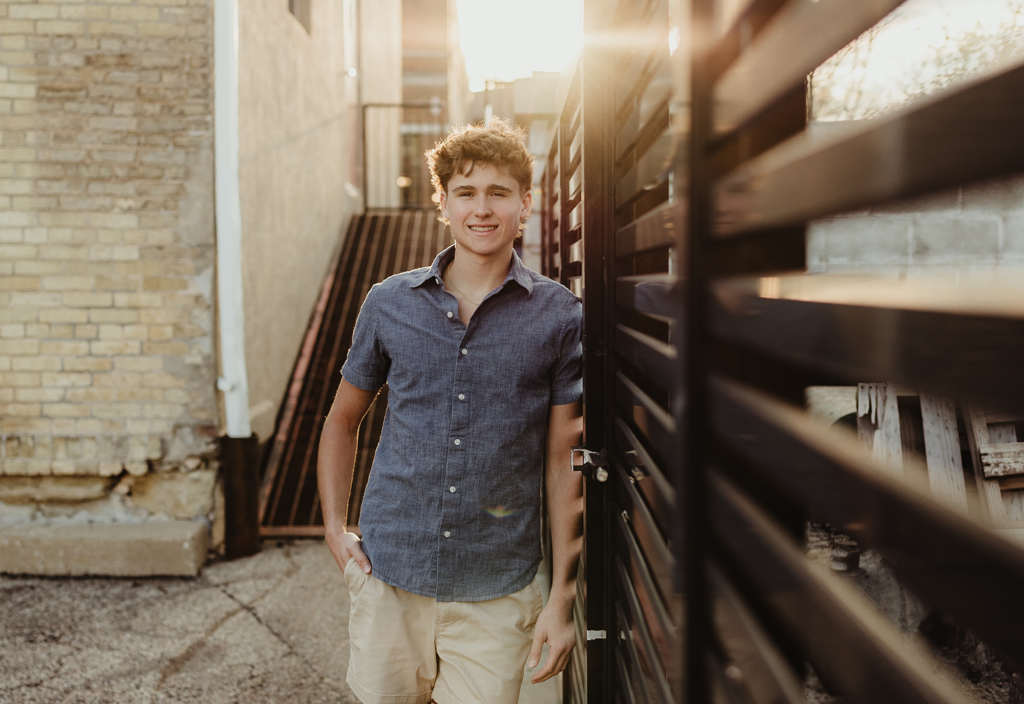 Central High School senior portrait in a downtown West Dundee alley during golden hour
