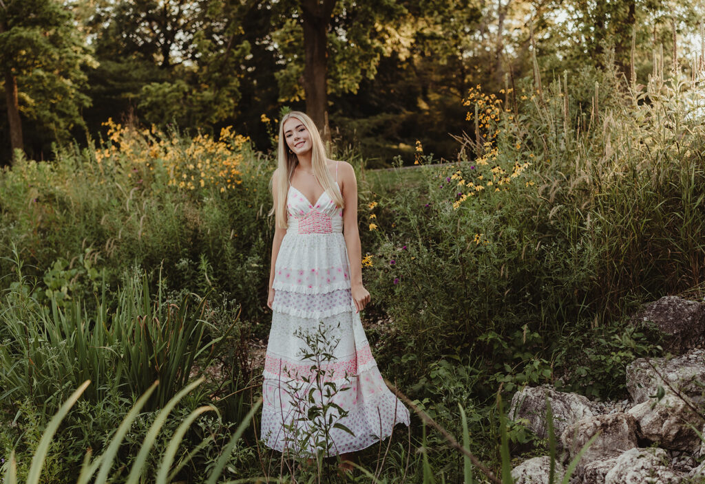 Central High School senior in a floral maxi dress among wildflowers at Fabyan Forest Preserve in Geneva, IL