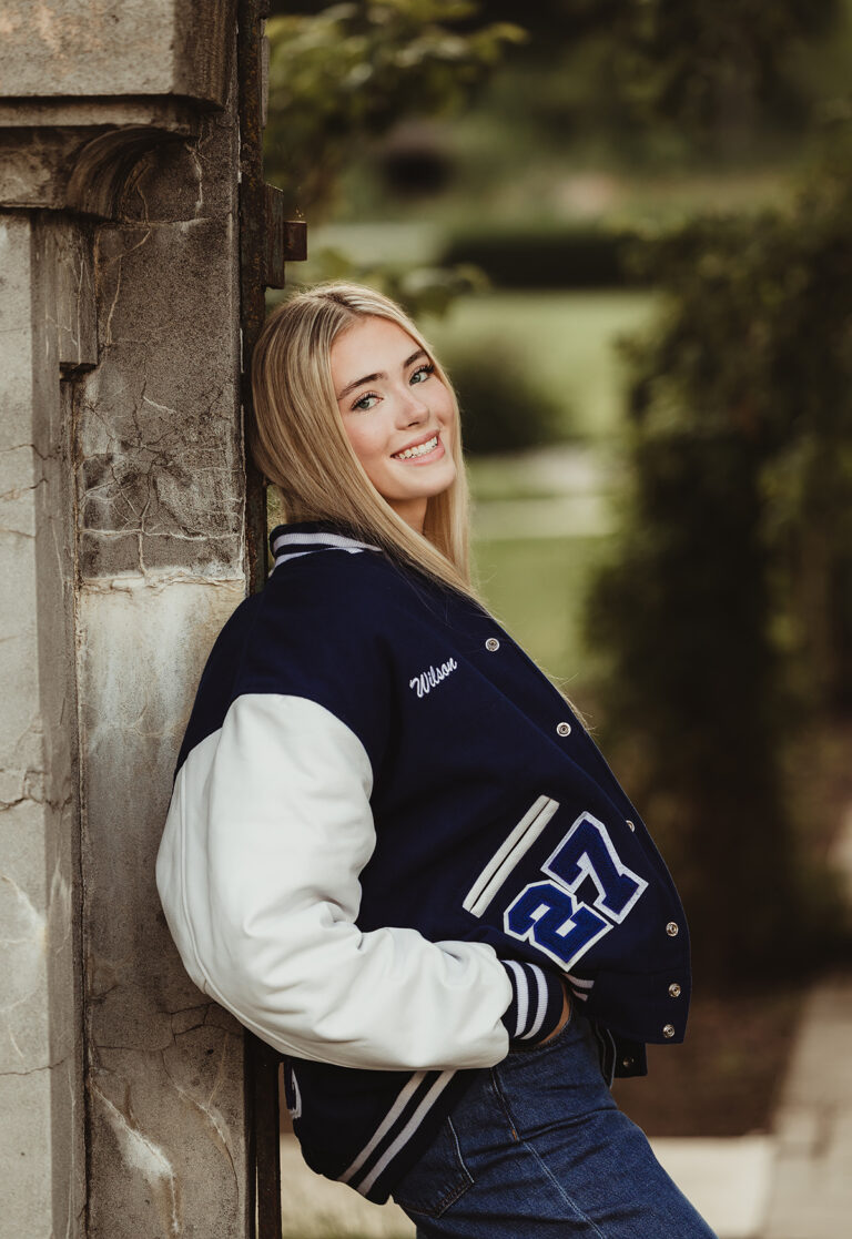 Central High School senior girl wearing her letterman jacket at Fabyan Forest Preserve in Geneva, Illinois