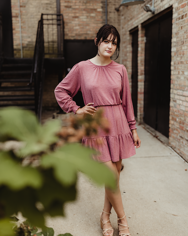 A Woman With Bangs Wearing Pink Dress