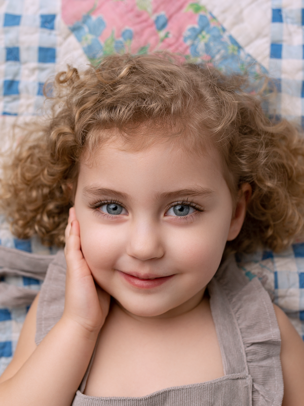 Cute Little Girl With Beautiful Eyes and Curly Hair