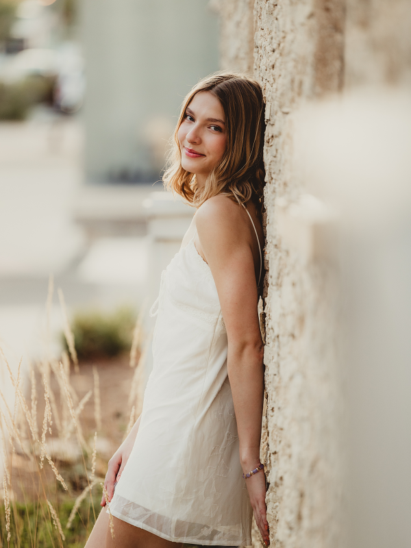 St. Charles East High School senior leaning against a historic limestone wall in downtown St. Charles, Illinois.